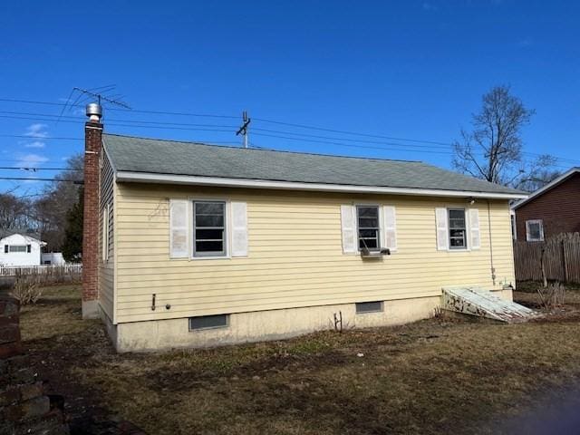 view of home's exterior with crawl space, a chimney, and fence