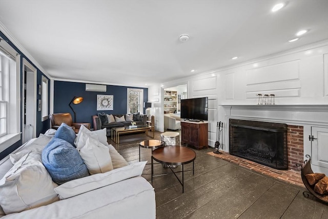 living room with a wall unit AC, crown molding, dark wood finished floors, a fireplace, and recessed lighting