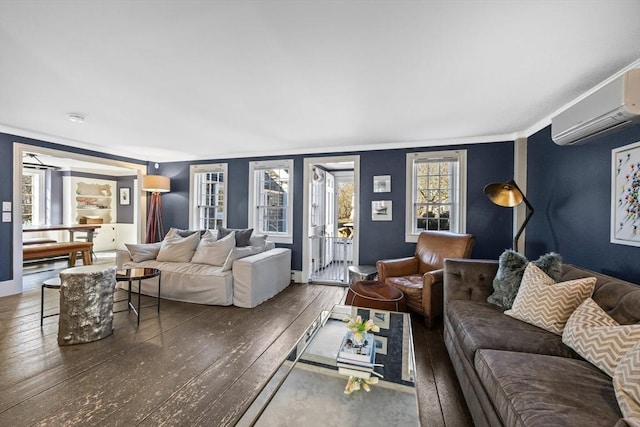 living area featuring a wall mounted air conditioner and hardwood / wood-style floors