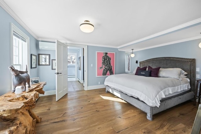 bedroom with light wood-type flooring, crown molding, baseboards, and a wall mounted AC