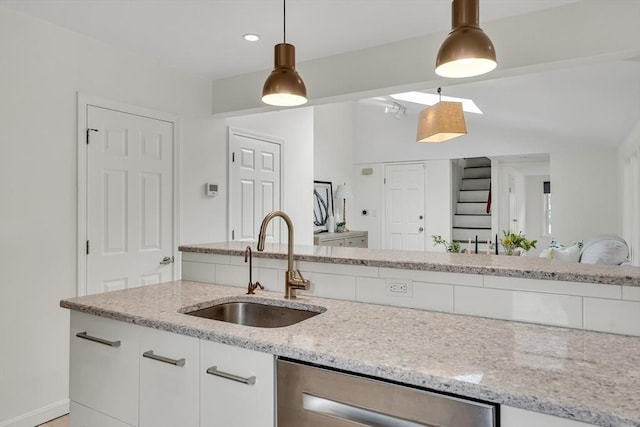 215 Norfolk St Unit 2, Cambridge, MA 02139 - kitchen with stainless steel dishwasher, light stone countertops, hanging light fixtures, white cabinetry, and recessed lighting
