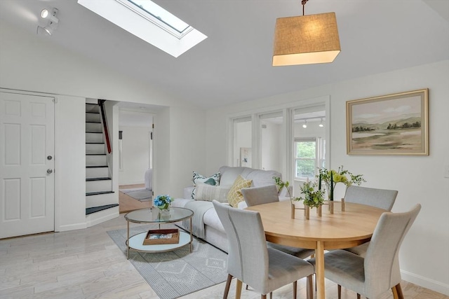 215 Norfolk St Unit 2, Cambridge, MA 02139 - dining room featuring stairway, vaulted ceiling, light wood finished floors, and a skylight