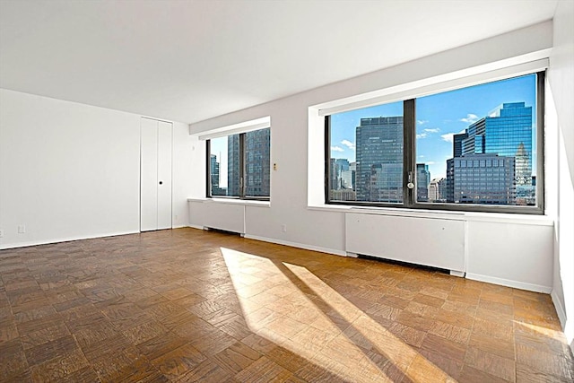 empty room with parquet floors and radiator