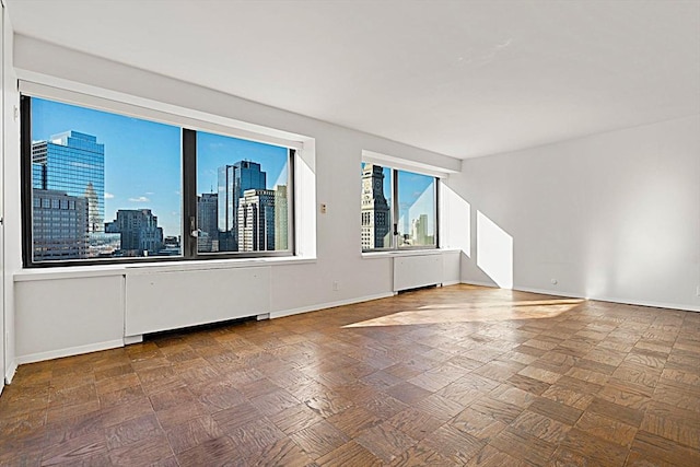 empty room with radiator and parquet floors