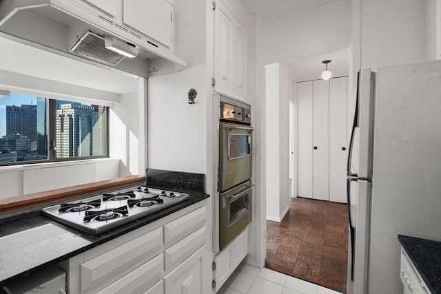 kitchen with range hood, fridge, gas stovetop, double wall oven, and white cabinets