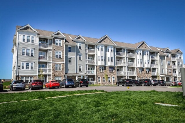 view of property featuring uncovered parking