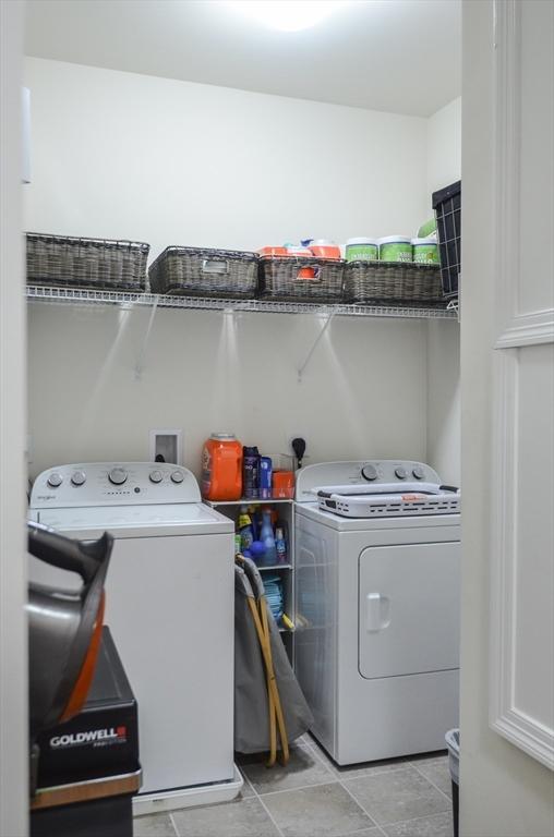 clothes washing area featuring independent washer and dryer and laundry area