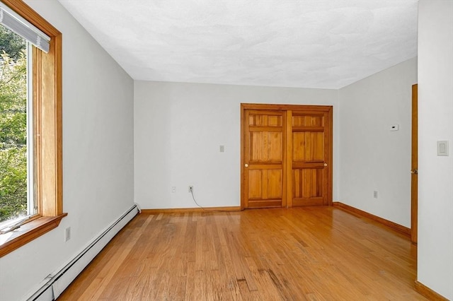 8 Horseshoe Dr, Acton, MA 01720 - unfurnished room featuring a baseboard radiator and light wood-style flooring
