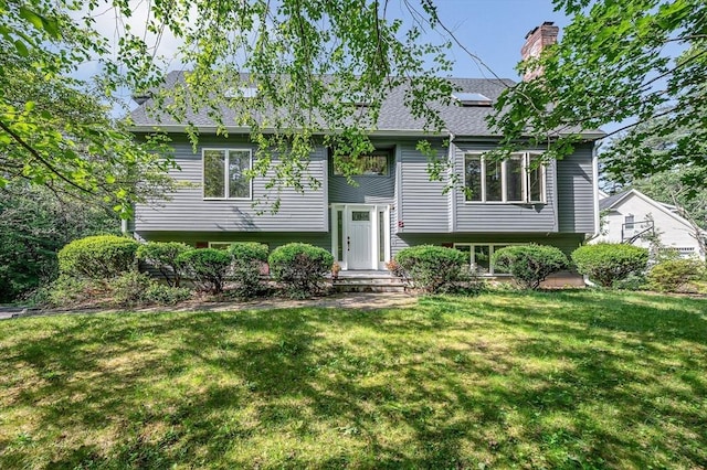 8 Horseshoe Dr, Acton, MA 01720 - raised ranch featuring a front lawn, a chimney, and a shingled roof