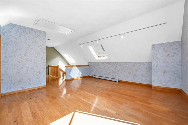 8 Horseshoe Dr, Acton, MA 01720 - bonus room featuring wallpapered walls, a baseboard radiator, wood finished floors, vaulted ceiling, and attic access