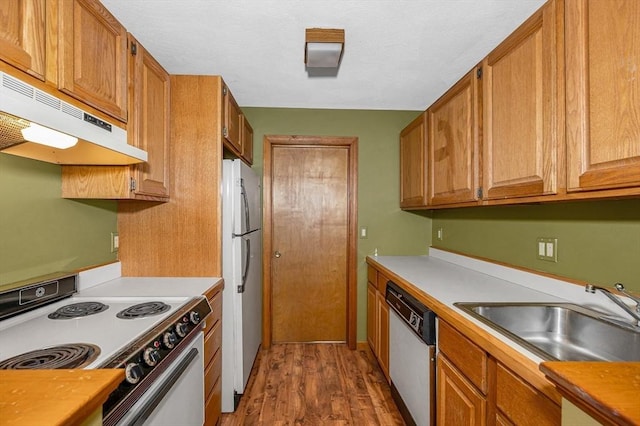 8 Horseshoe Dr, Acton, MA 01720 - kitchen featuring white appliances, under cabinet range hood, dark wood-style flooring, brown cabinets, and light countertops