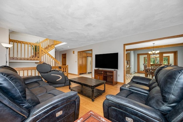 8 Horseshoe Dr, Acton, MA 01720 - living room with wood finished floors, a chandelier, and stairs