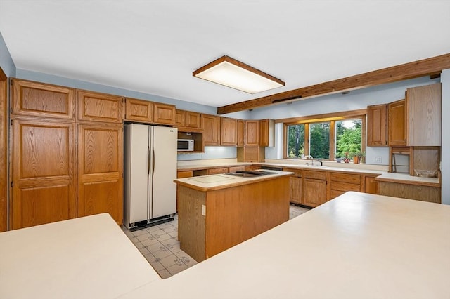 8 Horseshoe Dr, Acton, MA 01720 - kitchen featuring white appliances, light countertops, a kitchen island, light flooring, and brown cabinets