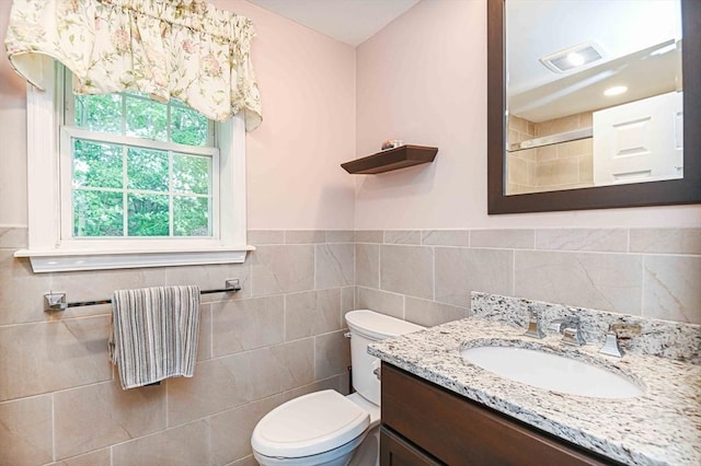 20 Bowdoin Dr, Haverhill, MA 01830 - full bathroom featuring vanity, a tile shower, tile walls, and a wainscoted wall