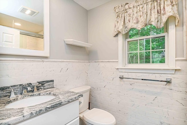 20 Bowdoin Dr, Haverhill, MA 01830 - bathroom with tile walls, vanity, wainscoting, and a shower