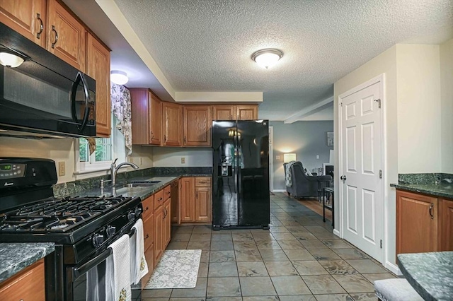20 Bowdoin Dr, Haverhill, MA 01830 - kitchen with black appliances, a textured ceiling, brown cabinets, and light tile patterned flooring