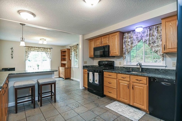 20 Bowdoin Dr, Haverhill, MA 01830 - kitchen featuring black appliances, a textured ceiling, healthy amount of natural light, and light tile patterned flooring