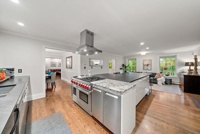 176 Spring St, Hopkinton, MA 01748 - kitchen featuring range with two ovens, island exhaust hood, modern cabinets, ornamental molding, and light wood-style flooring