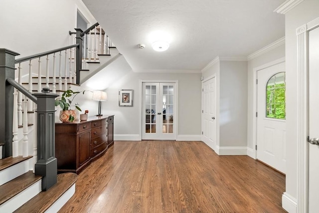 176 Spring St, Hopkinton, MA 01748 - entrance foyer featuring wood finished floors, french doors, stairway, baseboards, and ornamental molding