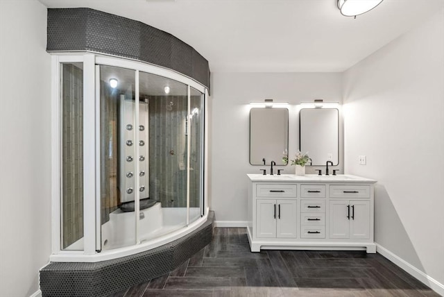 176 Spring St, Hopkinton, MA 01748 - full bath with baseboards, double vanity, tiled shower, and wood finished floors