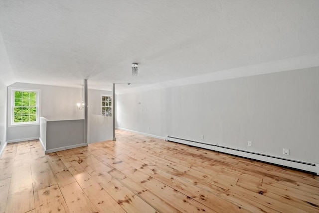 176 Spring St, Hopkinton, MA 01748 - unfurnished room with hardwood / wood-style flooring, baseboard heating, baseboards, and vaulted ceiling