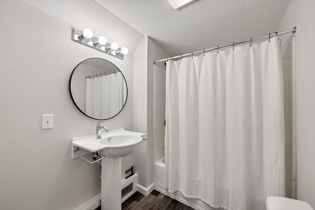 176 Spring St, Hopkinton, MA 01748 - bathroom with shower / bathtub combination with curtain, wood finished floors, baseboards, and toilet