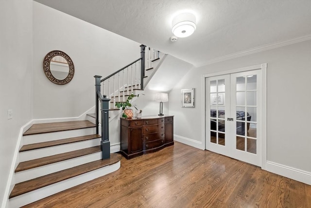 176 Spring St, Hopkinton, MA 01748 - stairway with baseboards, french doors, wood finished floors, and ornamental molding