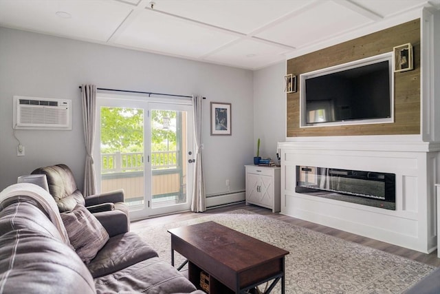 38 Carter St Unit 112, Everett, MA 02149 - living room with a wall unit AC, wood finished floors, baseboard heating, coffered ceiling, and a glass covered fireplace