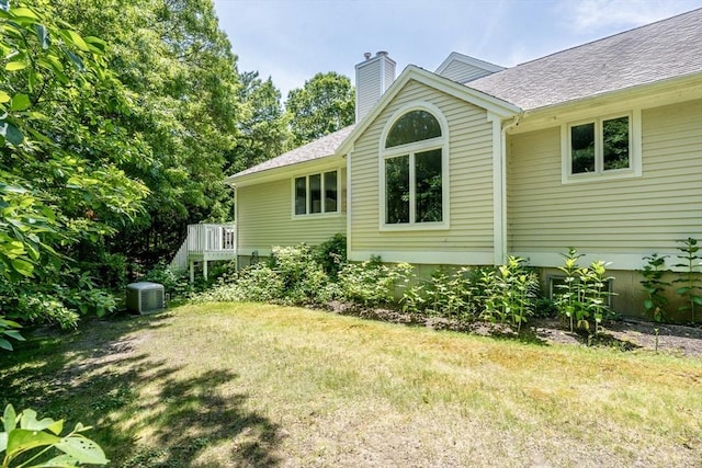 37 Pine Hill Blvd Unit 30, Mashpee, MA 02649 - view of side of property featuring a yard, a chimney, a shingled roof, and a deck