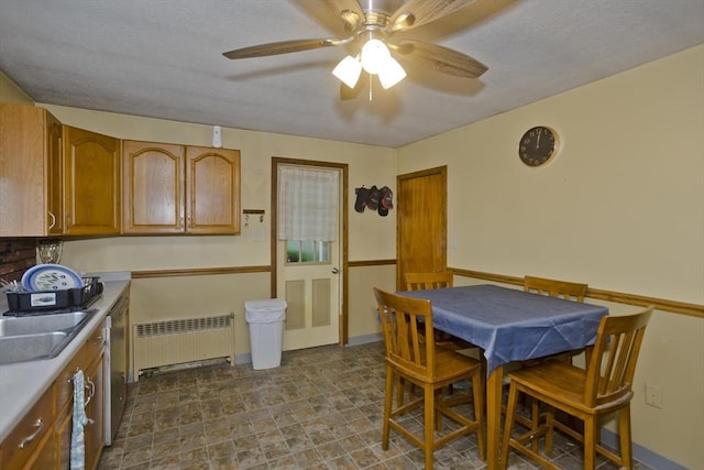 dining area featuring radiator, sink, and ceiling fan