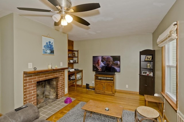 living room featuring a brick fireplace and hardwood / wood-style floors