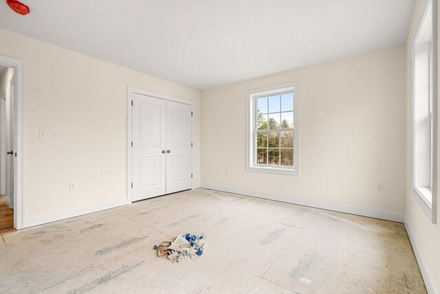 66-3 Parish Rd, Georgetown, MA 01833 - unfurnished bedroom featuring baseboards and a closet