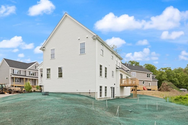 66-3 Parish Rd, Georgetown, MA 01833 - back of house featuring a residential view, a lawn, and a wooden deck