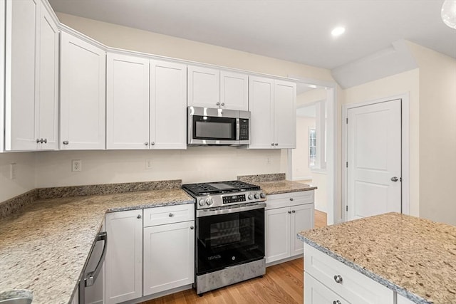 66-3 Parish Rd, Georgetown, MA 01833 - kitchen featuring appliances with stainless steel finishes, light wood-type flooring, white cabinetry, recessed lighting, and light stone countertops