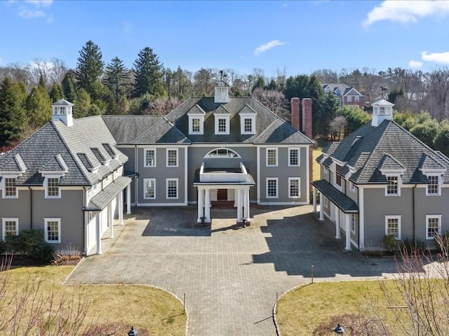 view of front of property with decorative driveway and a front yard