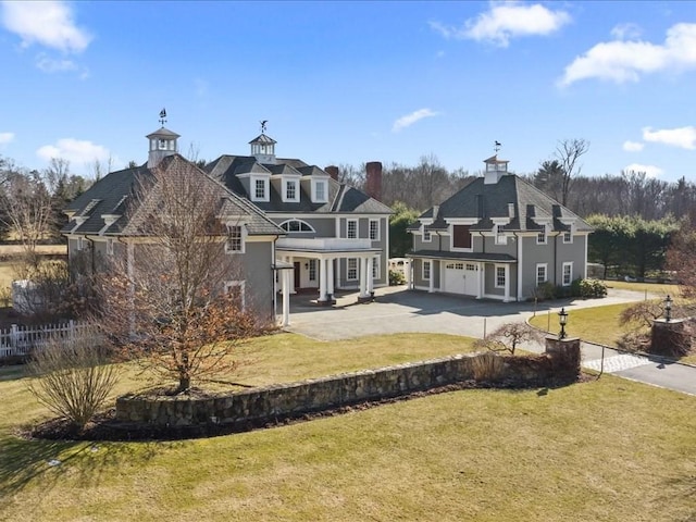 back of house featuring driveway, fence, a lawn, and a patio