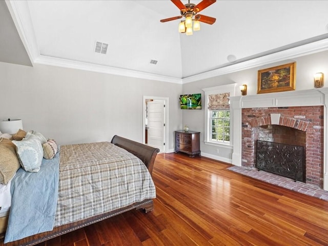 bedroom with ornamental molding, visible vents, high vaulted ceiling, and wood finished floors