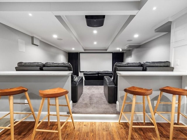 home theater featuring crown molding, wood finished floors, and recessed lighting