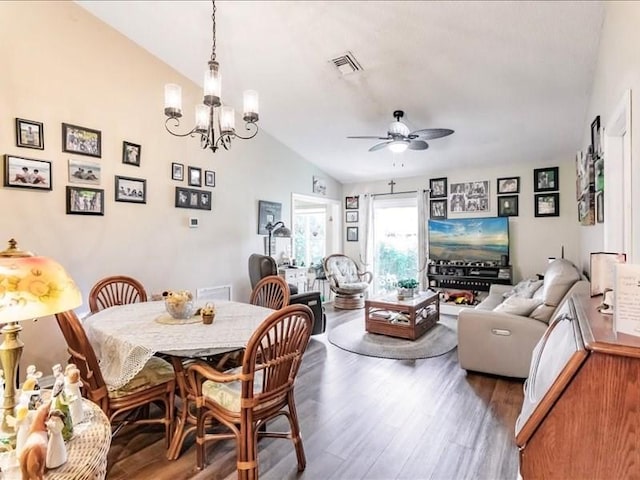 1244 Corktree E, Port Charlotte, FL 33952 - dining space with wood finished floors, a ceiling fan, a chandelier, and lofted ceiling