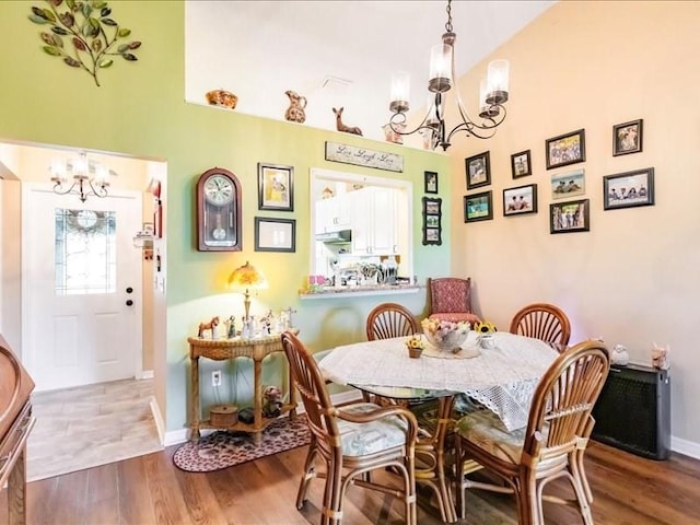 1244 Corktree E, Port Charlotte, FL 33952 - dining room with a chandelier, wood finished floors, and a towering ceiling