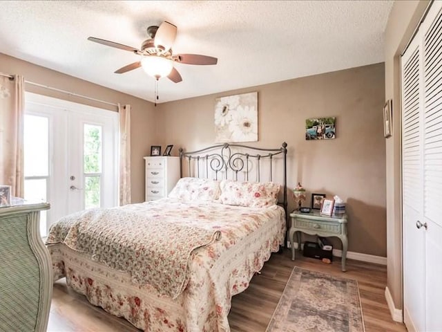 1244 Corktree E, Port Charlotte, FL 33952 - bedroom featuring a closet, wood finished floors, a textured ceiling, and ceiling fan
