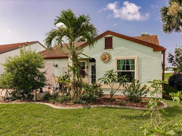 1244 Corktree E, Port Charlotte, FL 33952 - mediterranean / spanish home featuring stucco siding and a front lawn