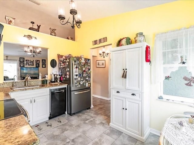 1244 Corktree E, Port Charlotte, FL 33952 - kitchen with black appliances, a chandelier, and white cabinetry