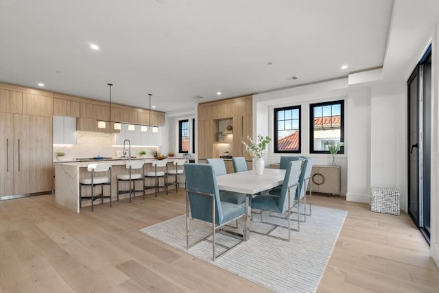 dining space with light wood-type flooring