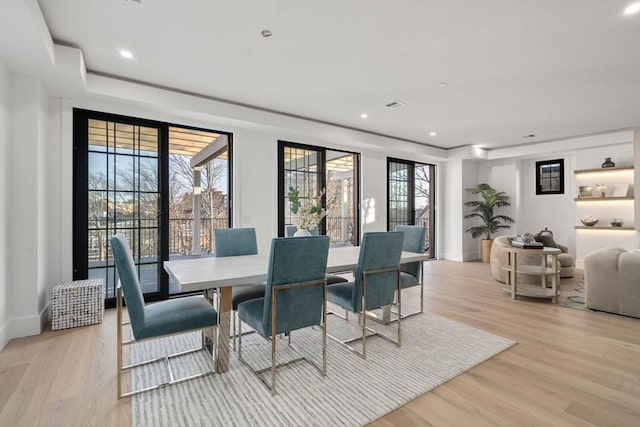 dining space featuring a healthy amount of sunlight and light wood-type flooring