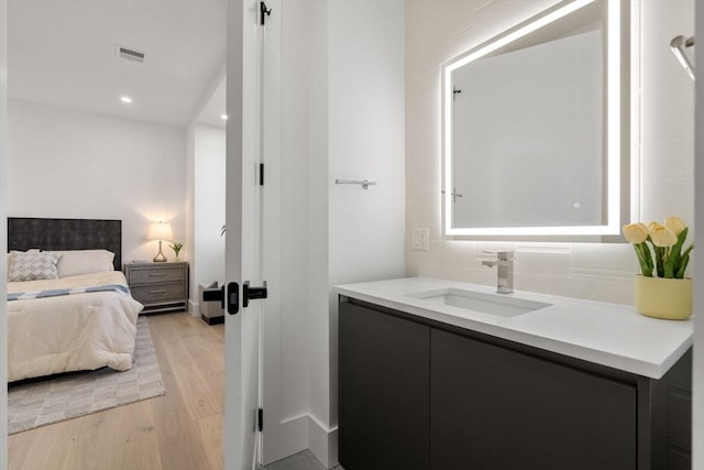 bathroom featuring hardwood / wood-style flooring and vanity