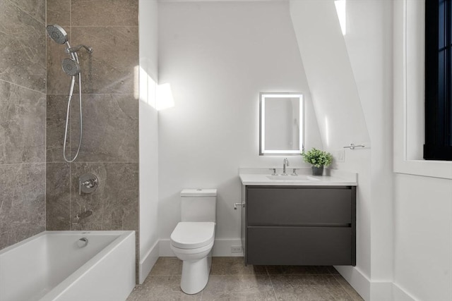 full bathroom featuring vanity, tiled shower / bath combo, and toilet