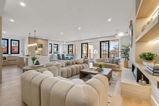 living room featuring sink and light hardwood / wood-style flooring