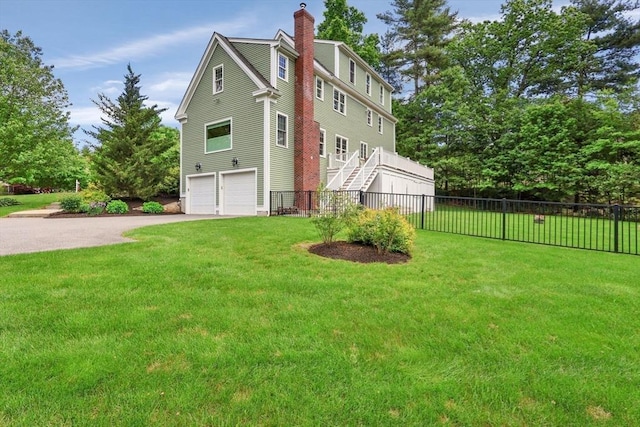 15 Sylvan Dr, Stow, MA 01775 - view of side of home featuring a garage, concrete driveway, and a chimney