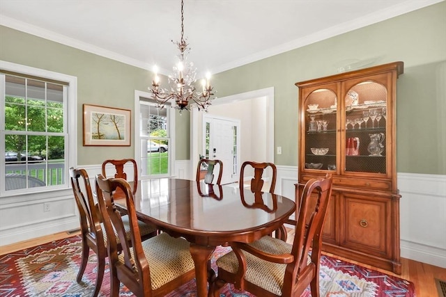 15 Sylvan Dr, Stow, MA 01775 - dining space with a chandelier, a wainscoted wall, light wood-style floors, ornamental molding, and a decorative wall